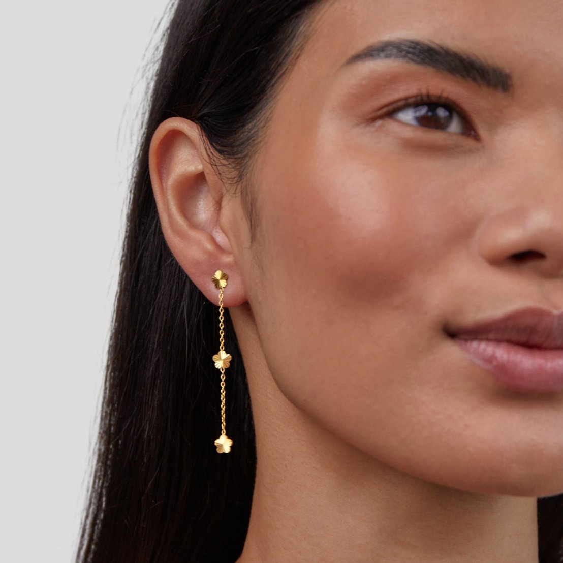 Flower Power Petal Drop Earrings, worn on an ear, gold flower drop with chain