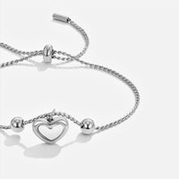 Forever Love Heart Bracelet, close-up of silver chain with heart charm on white background