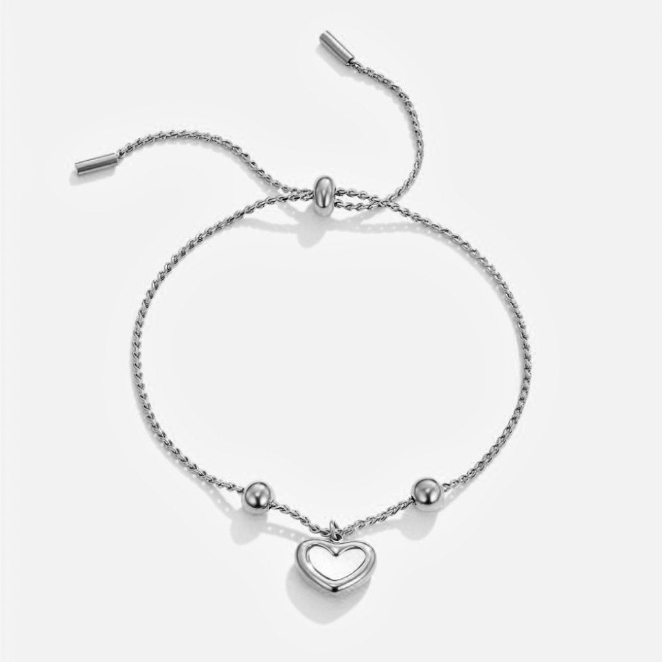 Forever Love Heart Bracelet, flat lay of a silver twisted-chain bracelet with heart charm and