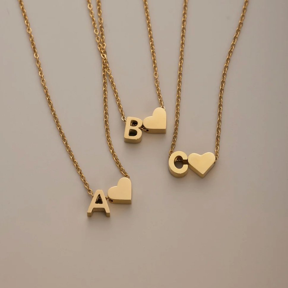Forever Love & Letter Gold Necklace, three gold letter necklaces laid flat, letters A, B and C