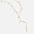 Lariat Pearl Drop Necklace, laid flat on white, long lariat with gold beads and pearls