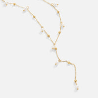 Lariat Pearl Drop Necklace, laid flat on white, long lariat with gold beads and pearls