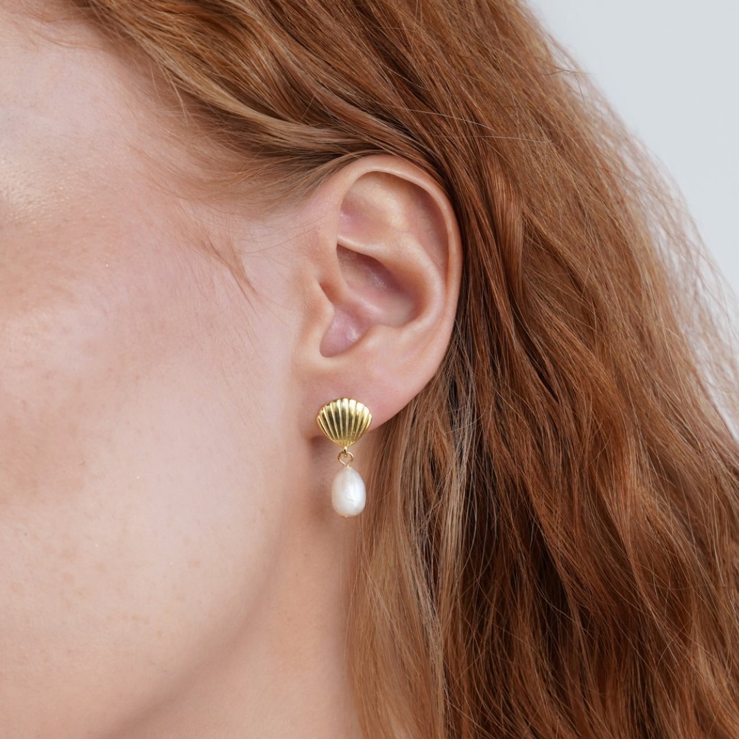 Freshwater Pearl & Gold Shell Earrings, worn on an ear with long auburn hair, gold shell stud