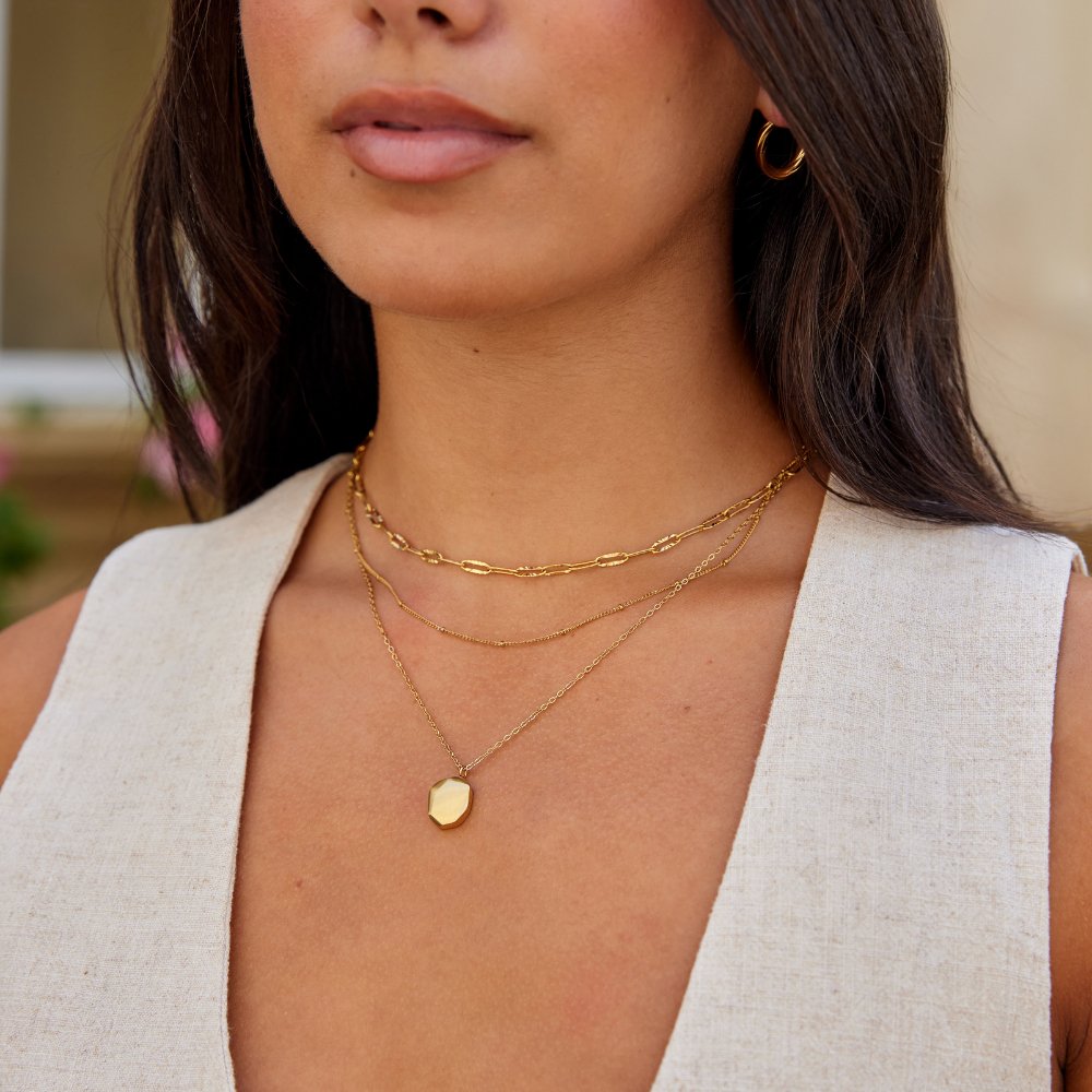 Geometric Pendant Necklace, worn layered at the neck with gold chains and a small hexagonal pendant