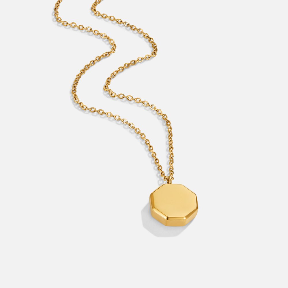 Geometric Pendant Necklace, gold chain necklace laid out on white with an octagonal pendant