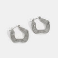Geometric Wave Silver Hoop Earrings, a pair of silver hoops with ridged, wavy square shapes on a white background
