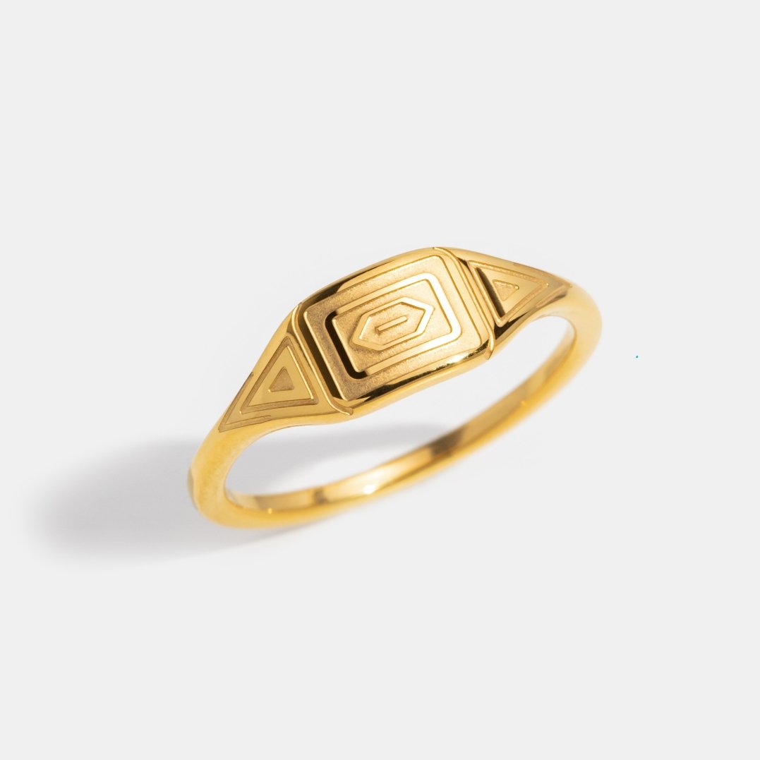 Gold Adaline Ring, gold ring on white background, angled view of engraved face