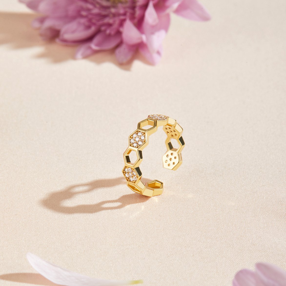 Gold & Crystal Honeycomb Ring, open gold ring with hexagon cells, set on beige fabric with