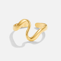 Gold Wave Ring, open wave-shaped ring in polished gold on a plain light background