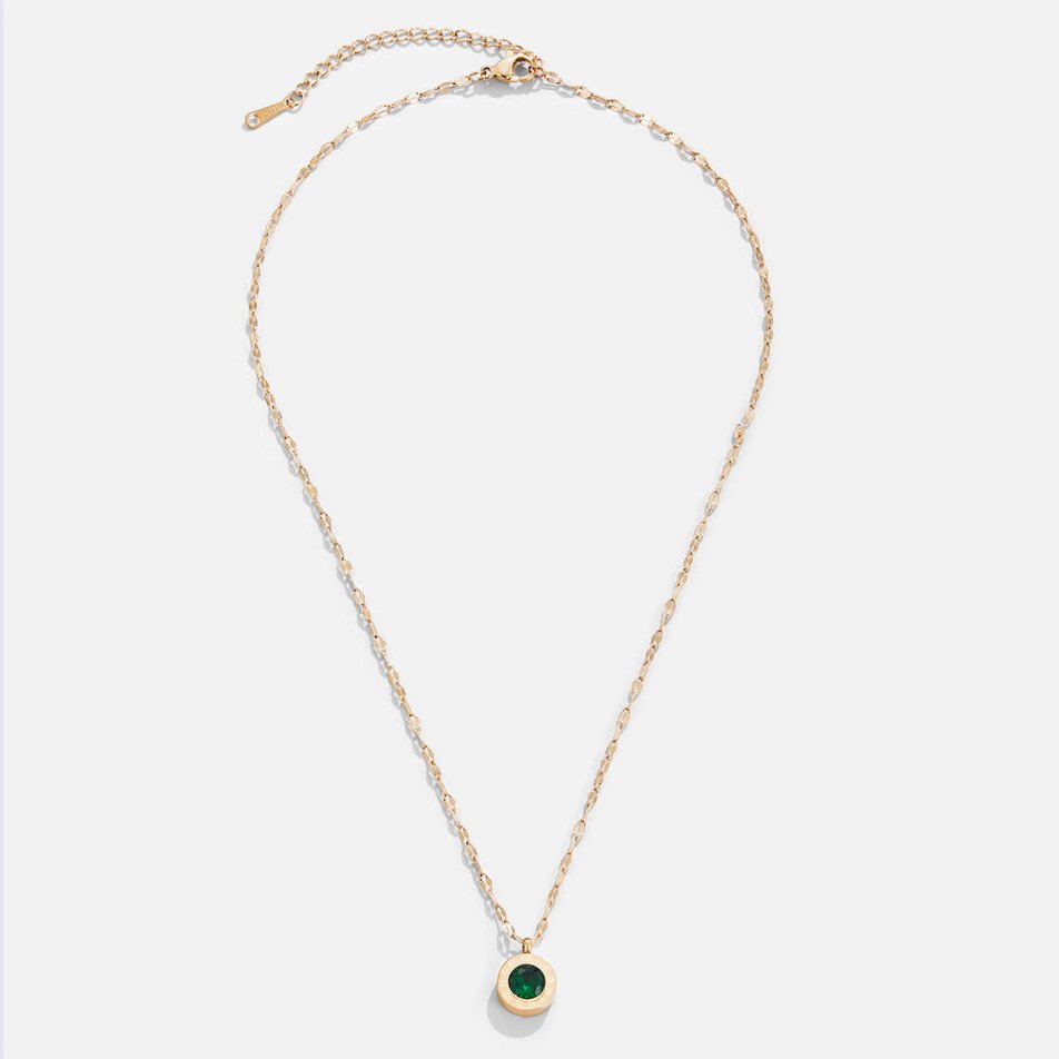 Green Crystal Athena Necklace, flat lay of a gold chain necklace with a round green stone pendant