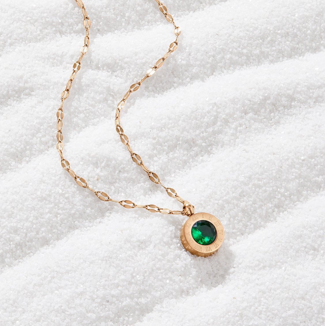 Green Crystal Athena Necklace, gold chain necklace with round green pendant on white sand