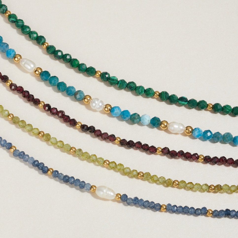 Green Peridot Bead Bracelet, five beaded necklaces laid out in parallel, in green and blue