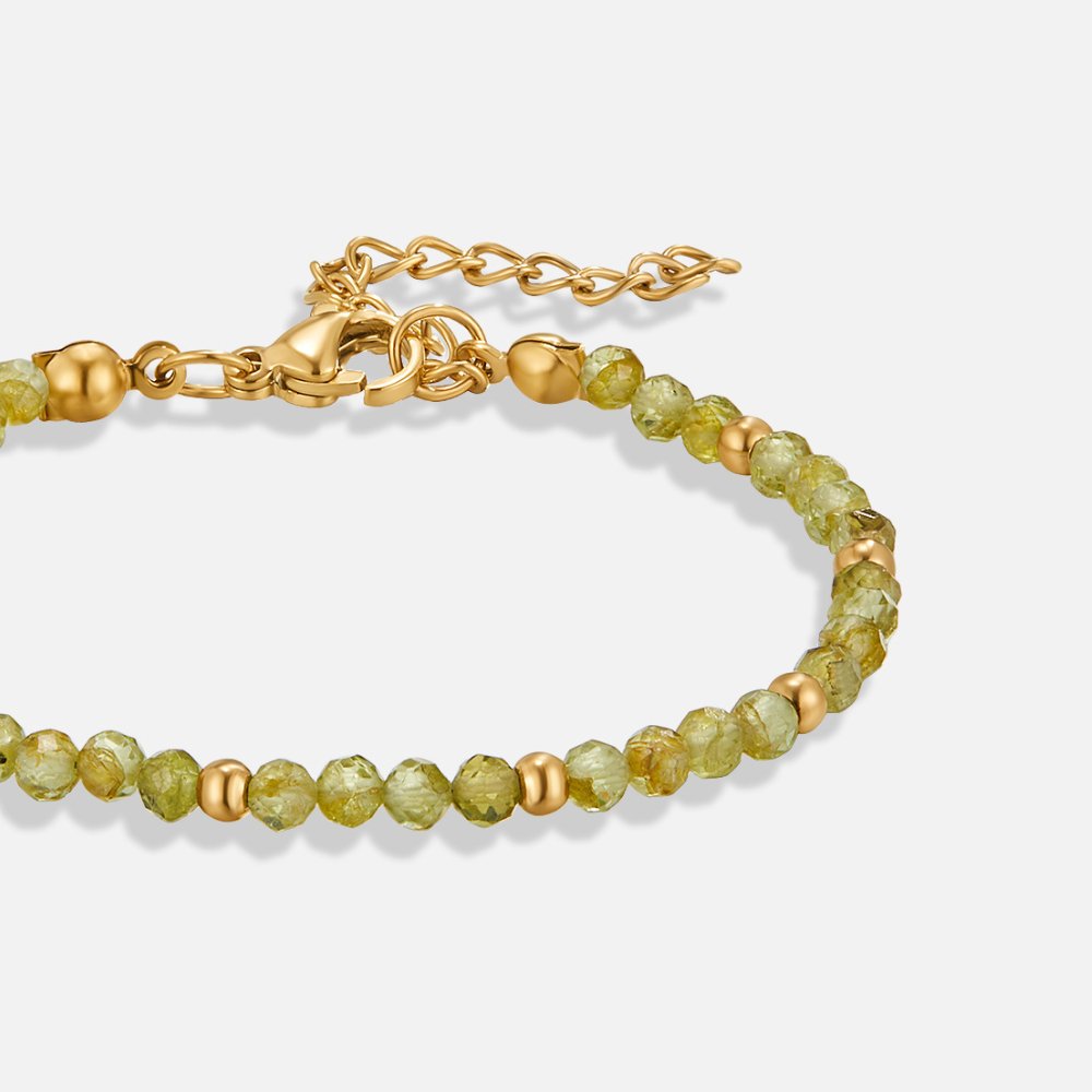 Green Peridot Bead Bracelet, flat lay close-up of green faceted beads with gold spacers and clasp