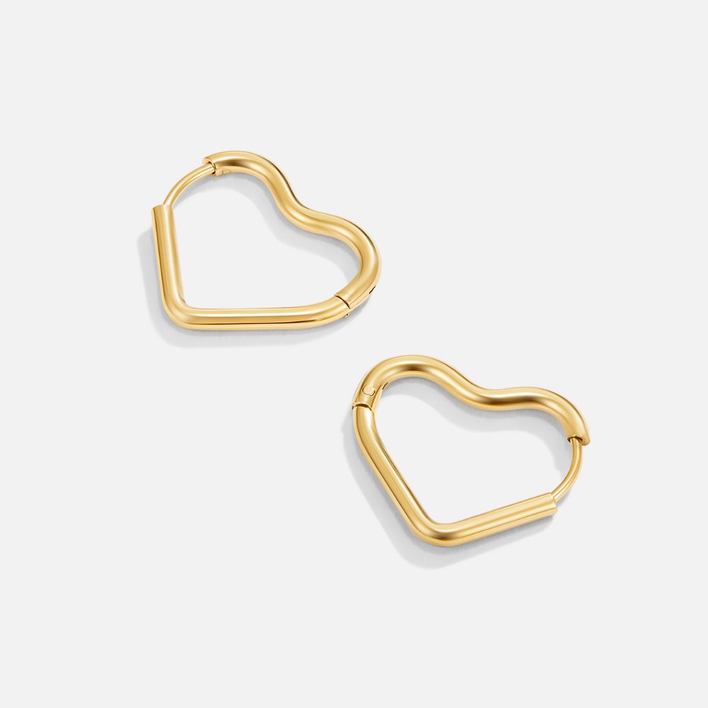 Heart Gold Hoops, pair of gold heart hoop earrings on a light grey background