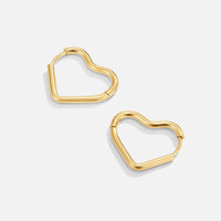 Heart Gold Hoops, pair of gold heart hoop earrings on a light grey background