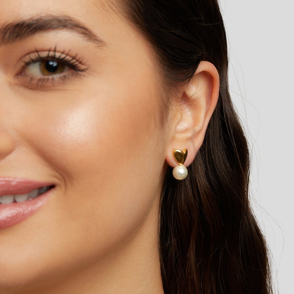 Heart & Pearl Earrings, worn on an ear, gold heart stud with a pearl drop