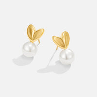 Heart & Pearl Earrings, pair of gold heart studs with round pearl drops on white background