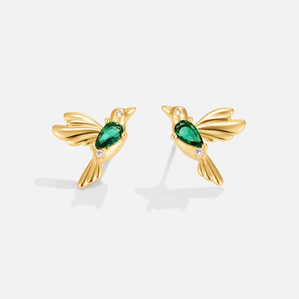 Hummingbird Stud Earrings, a pair of gold bird earrings with a green teardrop stone, on white