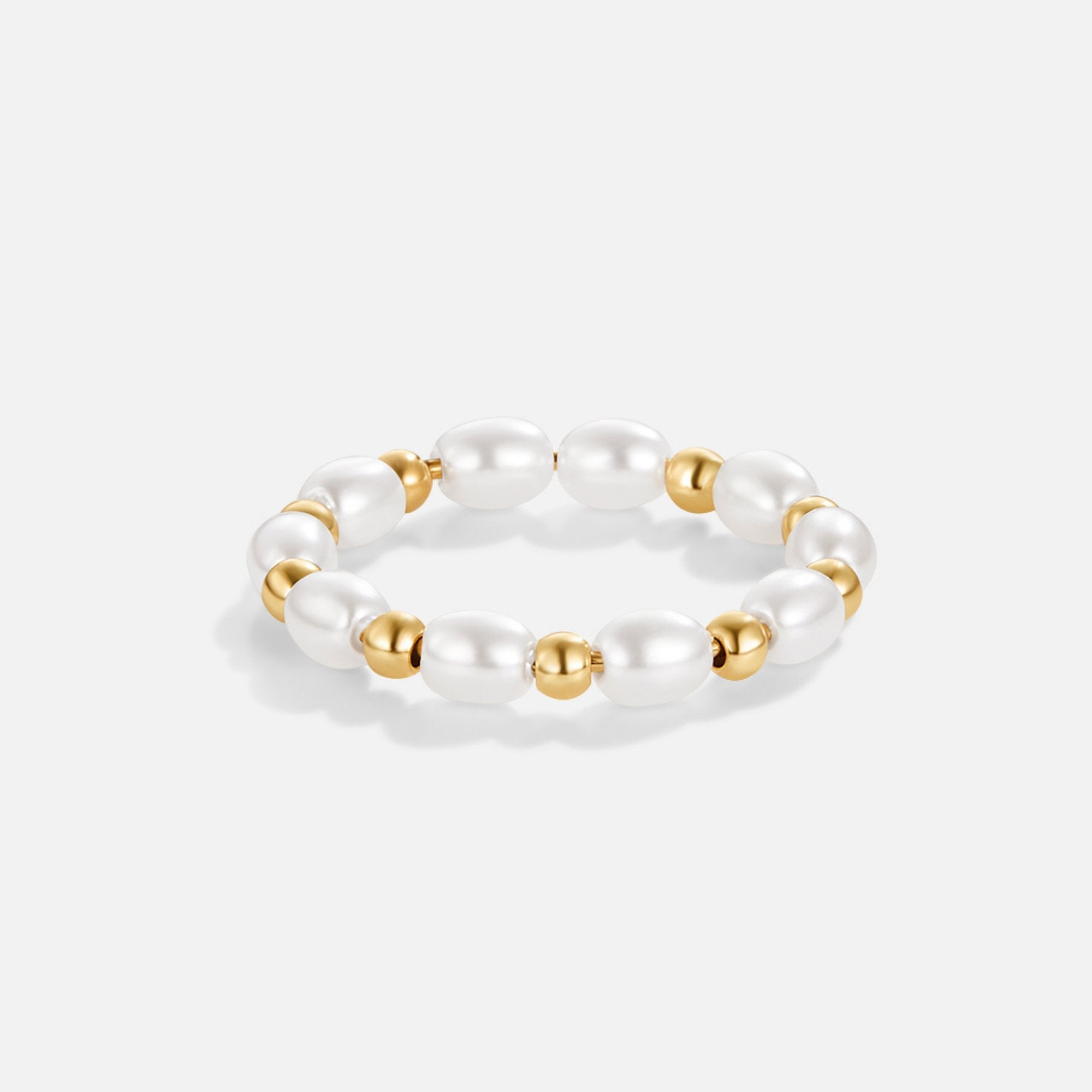 Kai Mini Pearl Ring, stretch ring of oval white pearls alternating with gold beads, on white