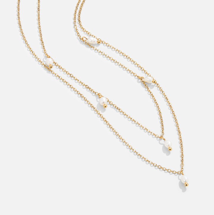 Kayla Pearl Drop Layered Necklace, two gold chains with pearls, layered on a white background