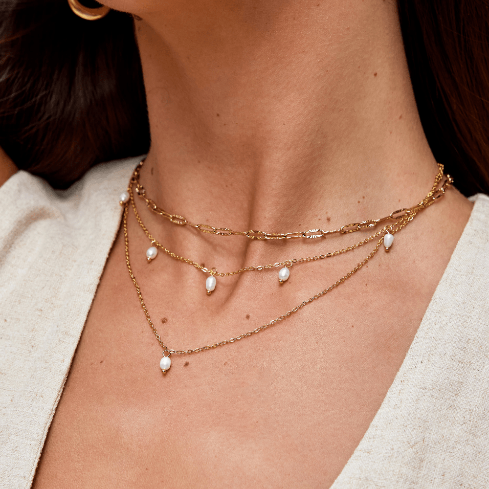 Kayla Pearl Drop Layered Necklace, worn layered at the neck over a linen top, with pearl drops