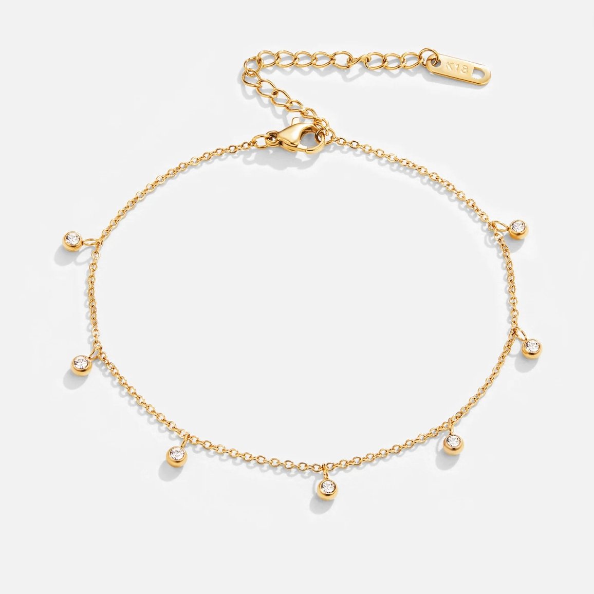 Lana Crystal Droplet Anklet, flat lay of a gold chain anklet with six crystal droplets