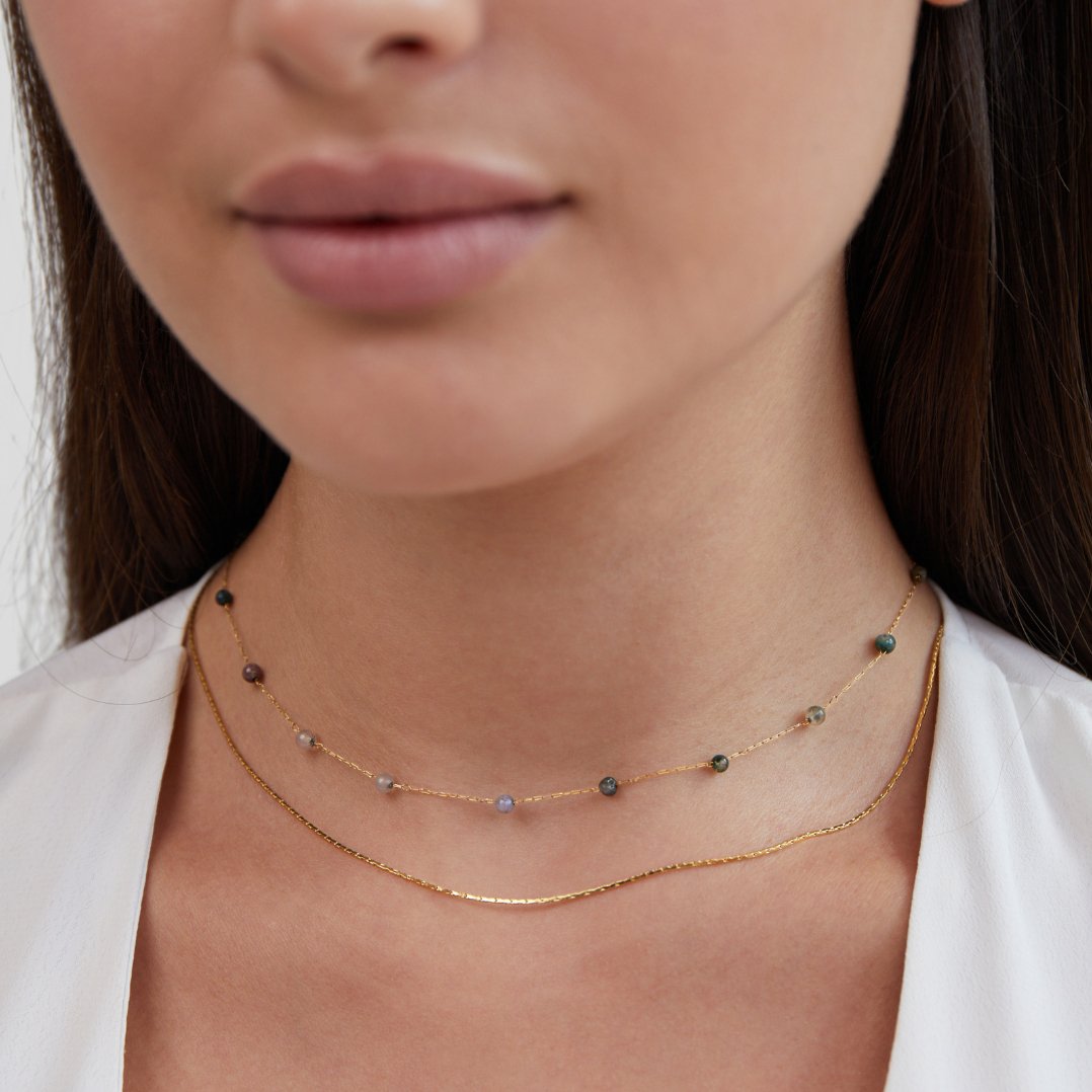 Layered Alana Gold & Stone Necklace, worn layered on a neck with a white top; beaded chain