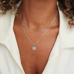 Layered Disc Necklace Silver, worn on a neck with a white open-collar shirt, silver
