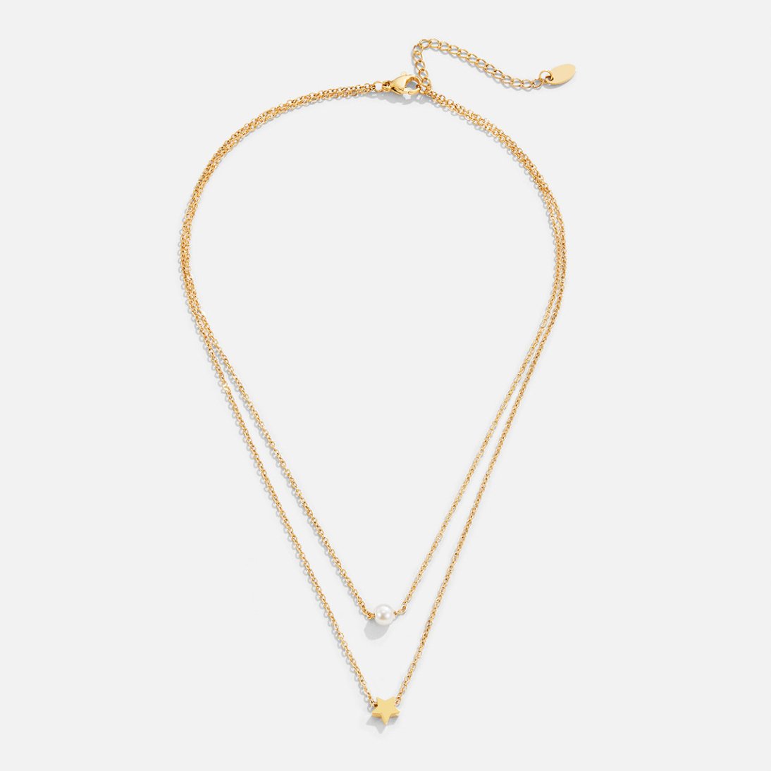 Layered Gold Star & Pearl Necklace, flat lay of two gold chains with a pearl and a star