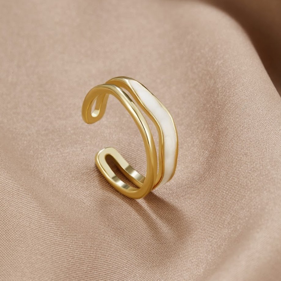 Layered Sahara Gold Ring, open gold ring with white enamel band on beige fabric