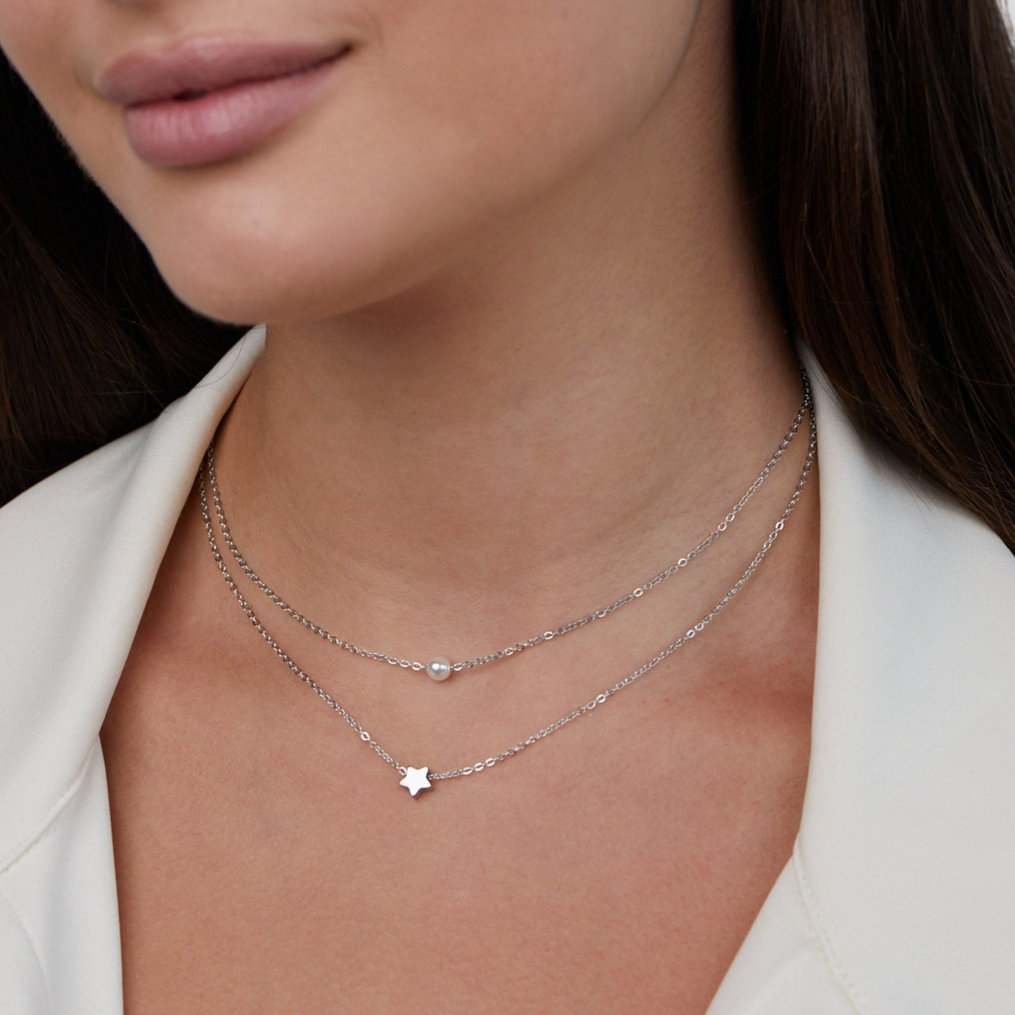 Layered Silver Star & Pearl Necklace, worn on a neck with a white collar, two fine chains