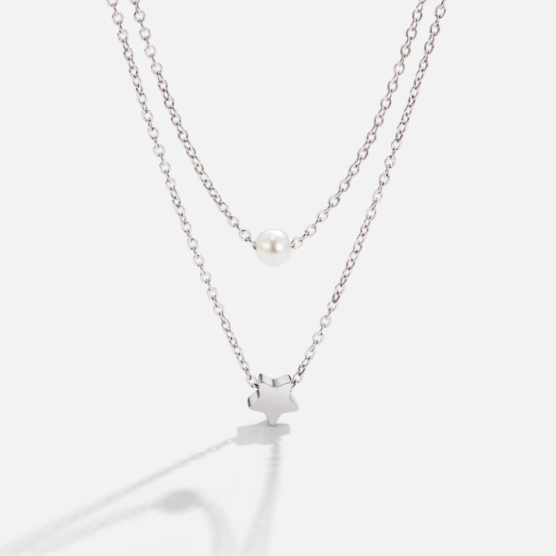 Layered Silver Star & Pearl Necklace, two silver chains layered, a pearl and a star pendant on