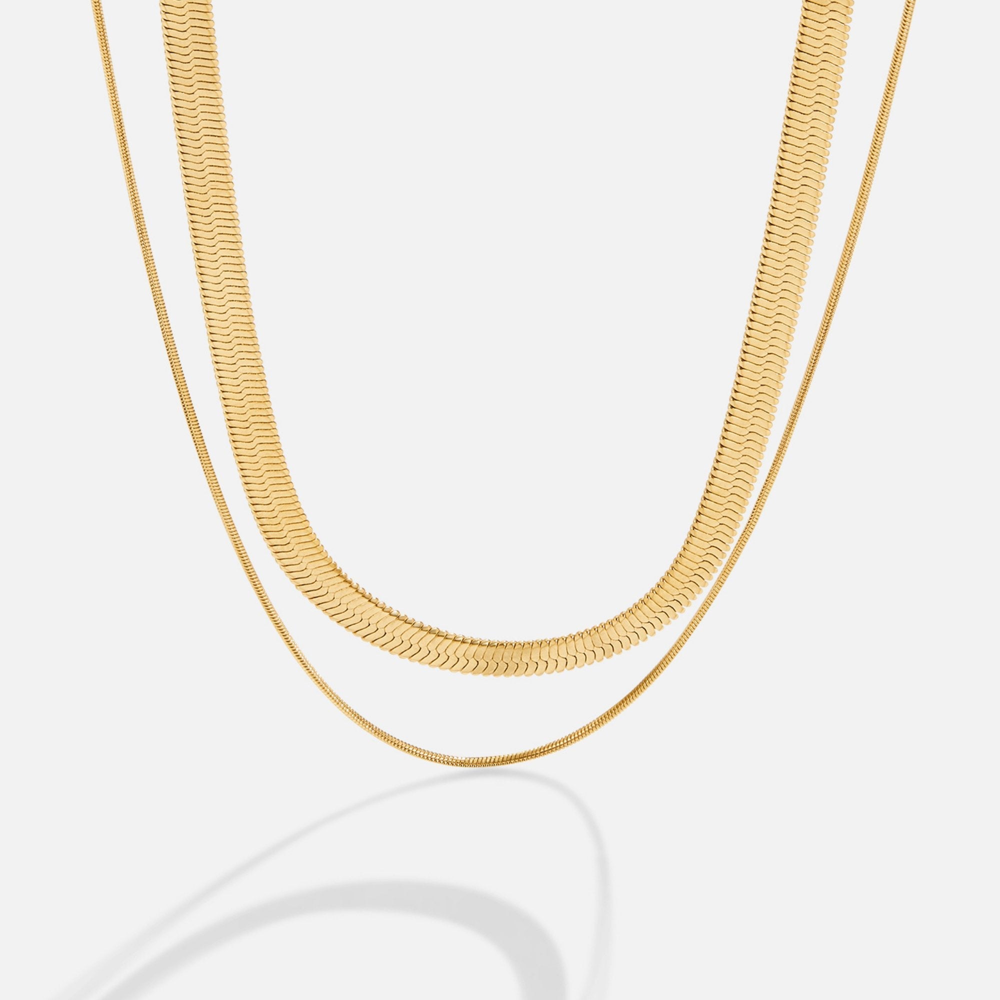Layla 18K Gold Layered Necklace, two gold chains layered on a white background, one wide and