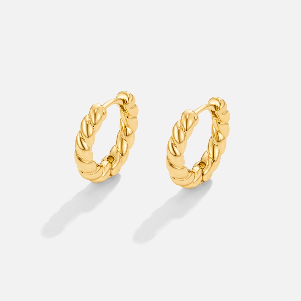 Layla Gold Twist Earrings, pair of twisted gold hoop earrings on a white background