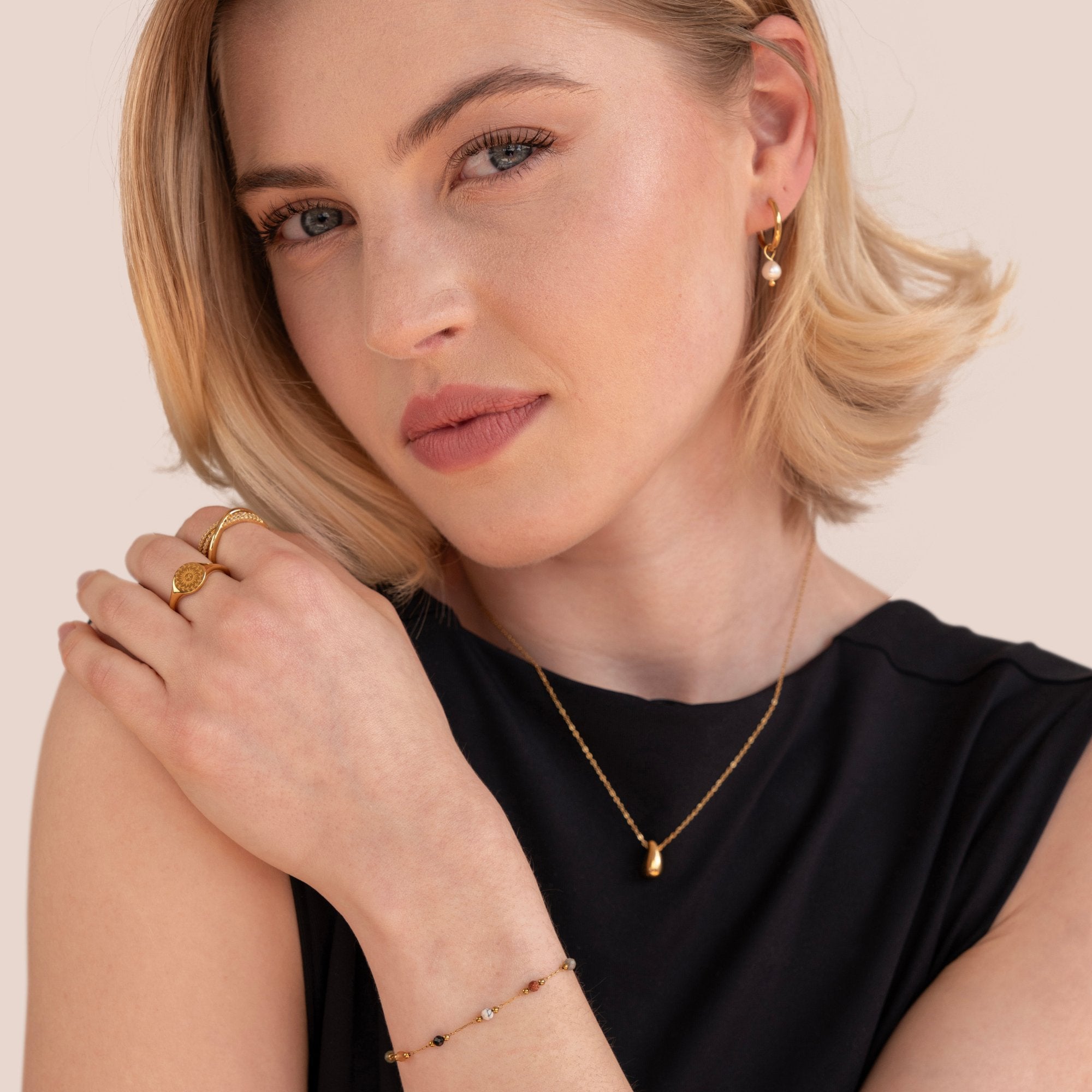Lulu Beaded Stone Bracelet, worn on a model with gold rings, necklace and earrings