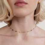 Lulu Beaded Stone Necklace, worn around a neck with a gold stud earring visible