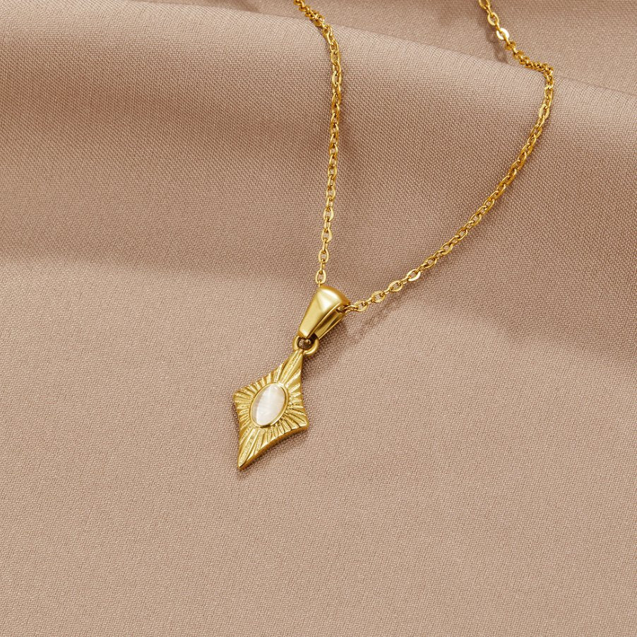 Luna White Opal Gold Necklace, gold pendant with white oval stone on beige fabric