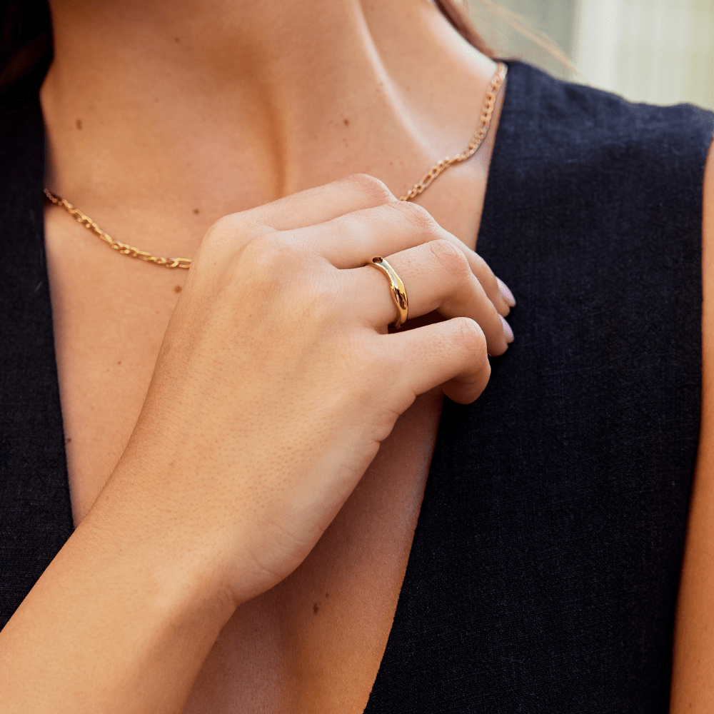 Madison Chunky Wave Ring, worn on a hand against a dark sleeveless top, with a gold chain necklace