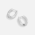 Madison Silver Hoop Earrings, pair of polished silver oval hoop earrings on a plain white background