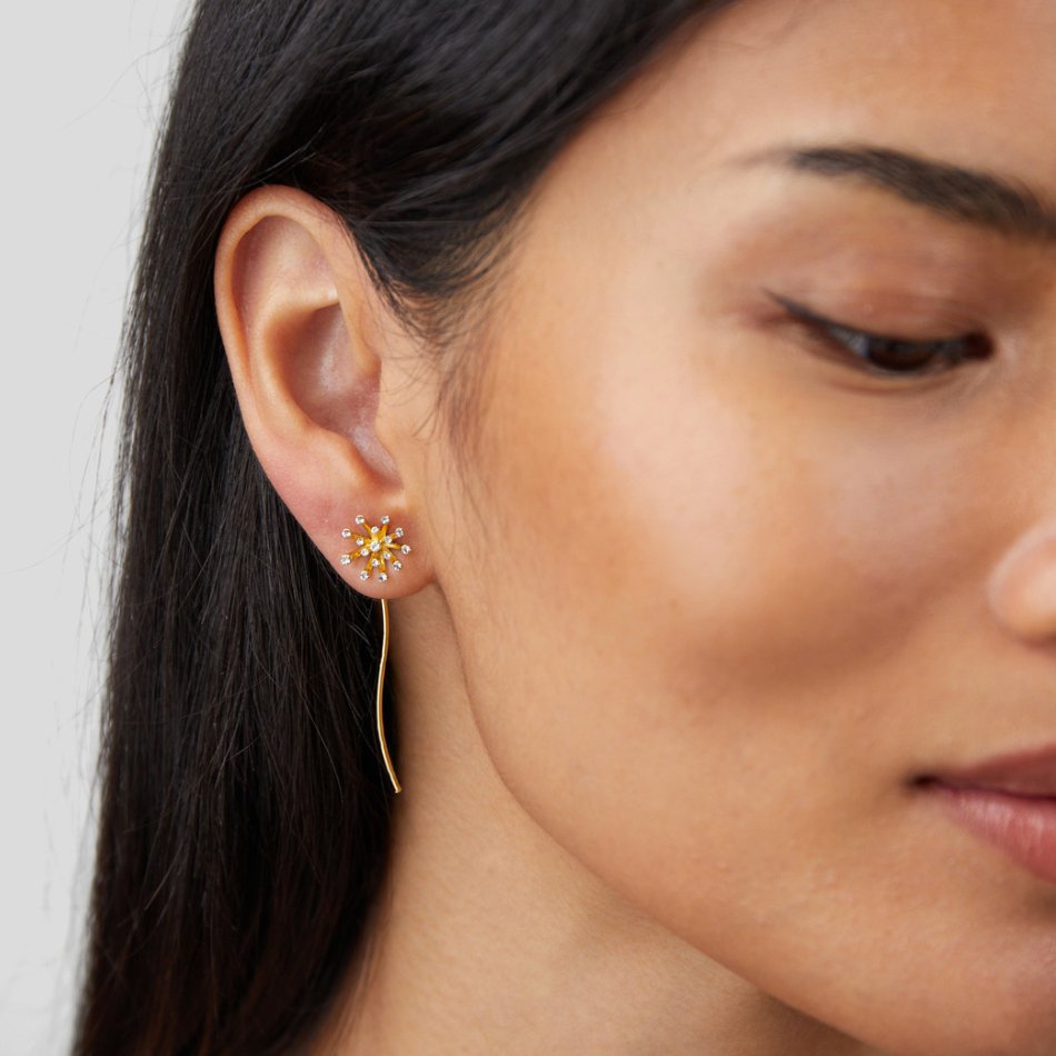 Make A Wish Dandelion 18K Gold Earrings, worn on an ear, gold starburst stud with a curved