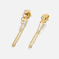 Mara Crystal Chain Earrings, pair of gold stud earrings with dangling chains on white
