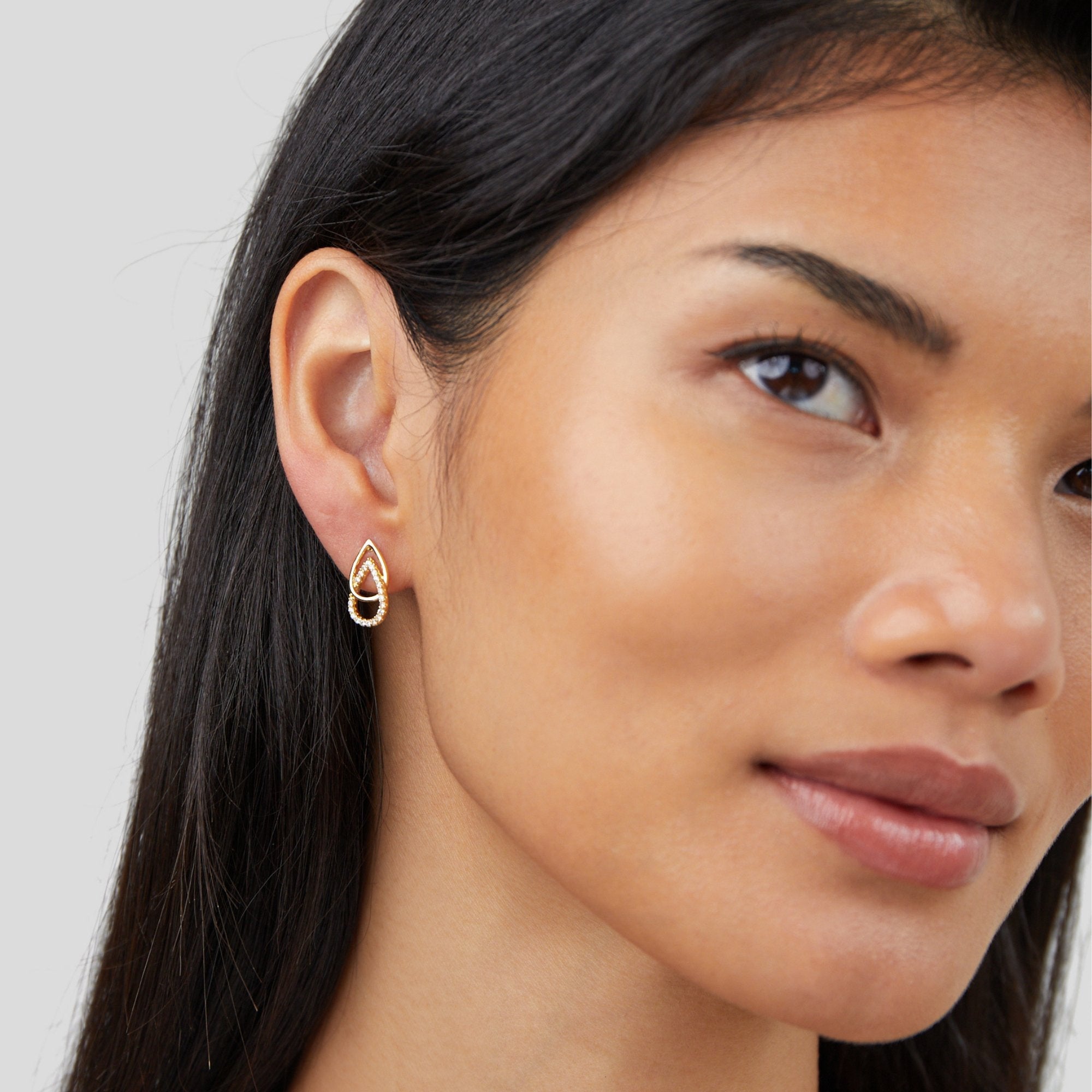 Mara Teardrop Link Earrings, worn on an ear by a woman with long dark hair