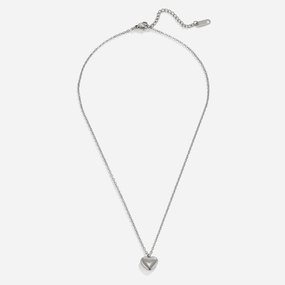 Marina Love Silver Necklace, flat lay of a thin silver chain with a puffed heart pendant