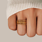 Marissa Layered Gold Leaf Ring, worn on a finger in a cream knit sleeve, three stacked gold bands