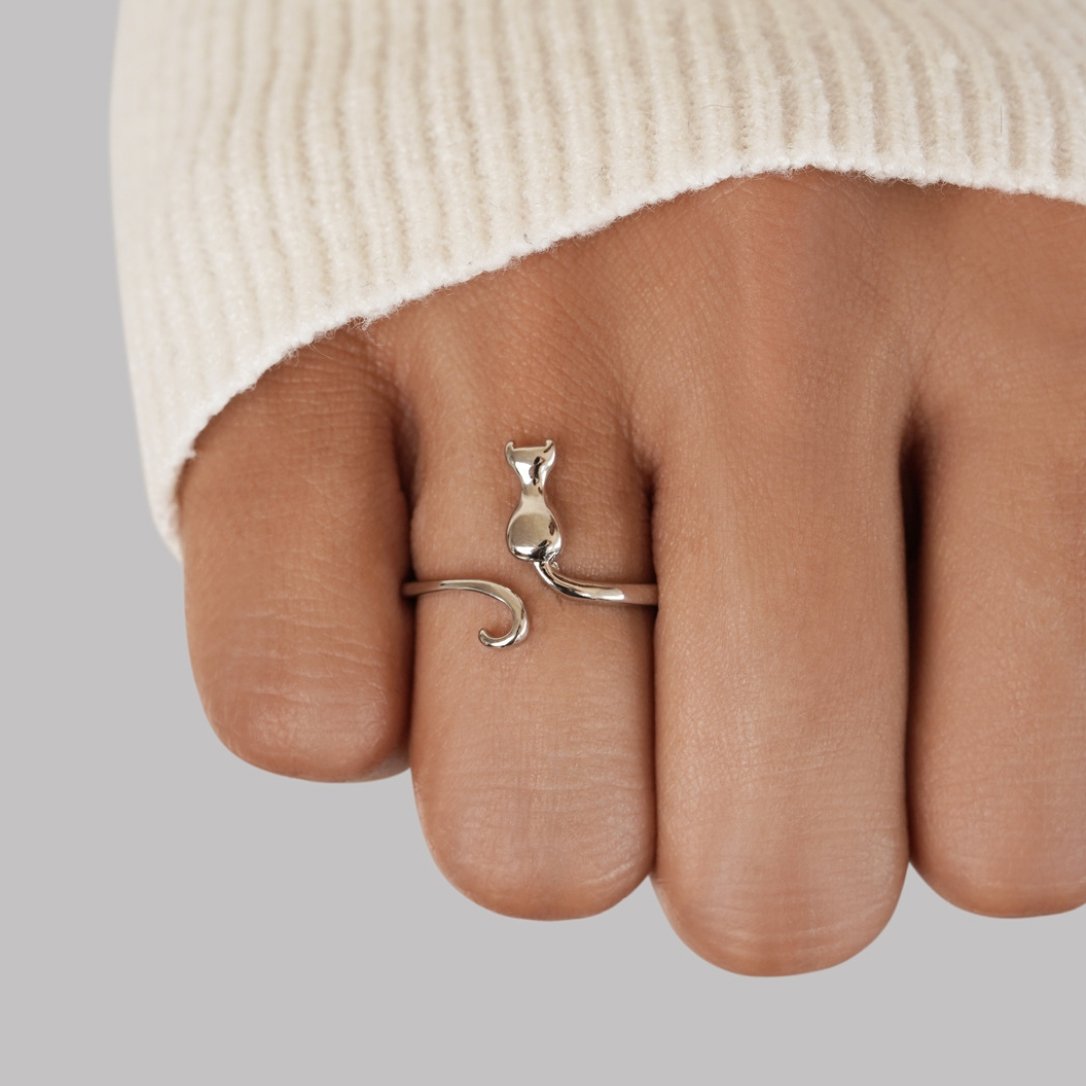 Midnight Cat Silver Ring, worn on a finger with a cream knit sleeve behind it