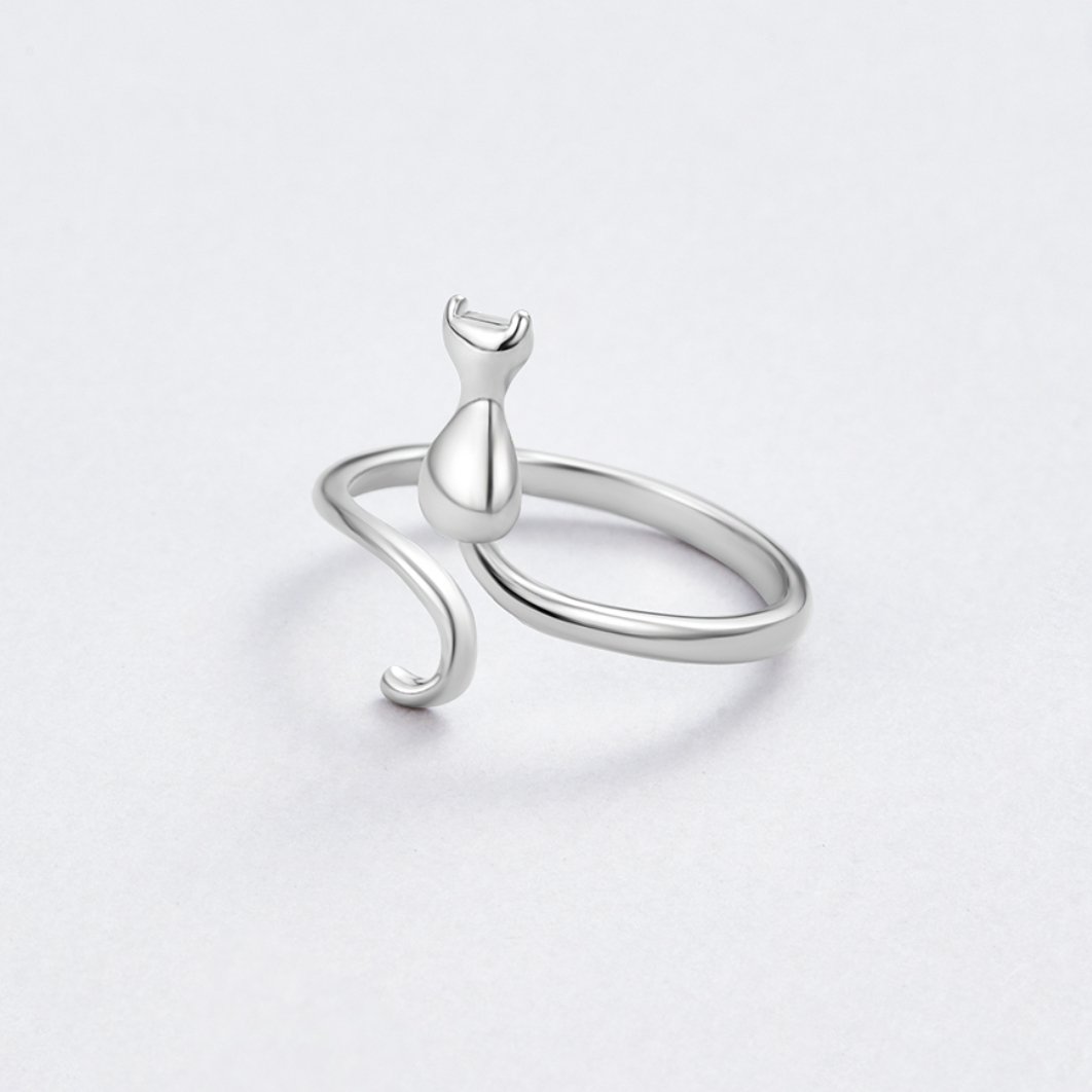 Midnight Cat Silver Ring, open silver ring with a cat-shaped figure, on a pale grey surface