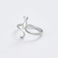 Midnight Cat Silver Ring, open silver ring with a cat-shaped figure, on a pale grey surface