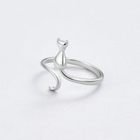 Midnight Cat Silver Ring, open silver ring with a cat-shaped figure, on a pale grey surface