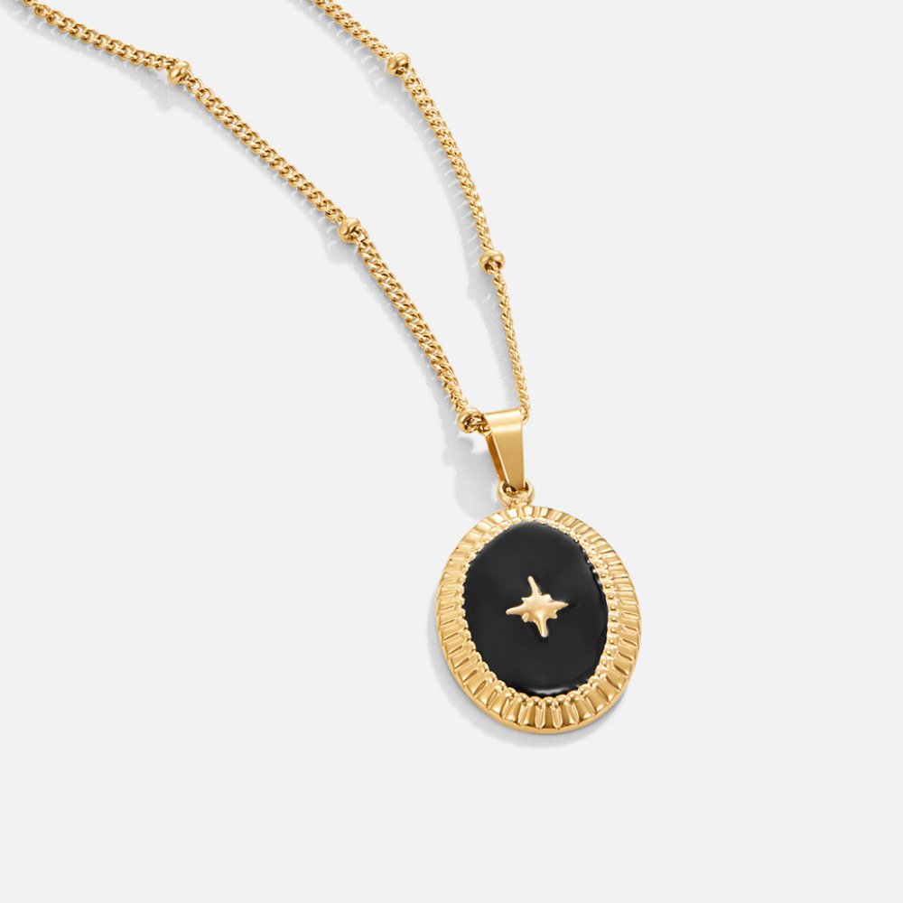 Midnight Star Onyx Necklace, gold necklace pendant with black enamel and a gold star, on white