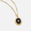 Midnight Star Onyx Necklace, gold necklace pendant with black enamel and a gold star, on white